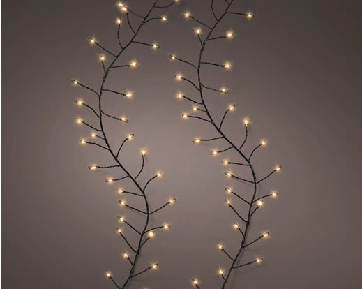 A string of micro LED lights with a classic warm bulb and green wire, displaying a branch-like structure against a dark background.